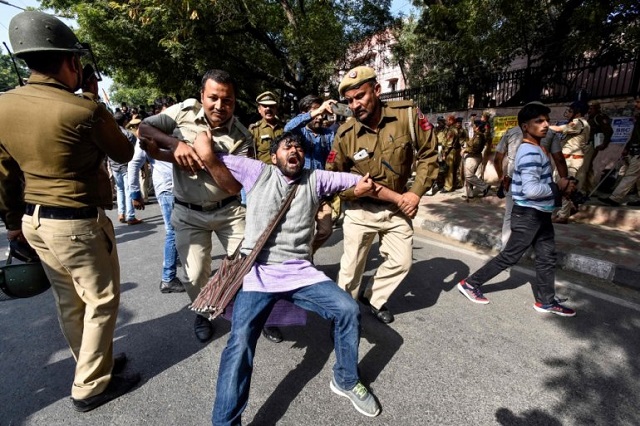 security personnel hold a jawaharlal nehru university jnu student during a students protest against hostel fee hike as security measures have been reinforced from jnu campus along the road to the march protest in new delhi on november 18 2019 photo afp