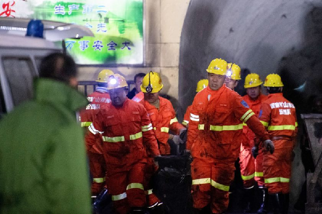 rescuers carry a victim at the site of a coal mine explosion in china s northern shanxi province early tuesday photo afp