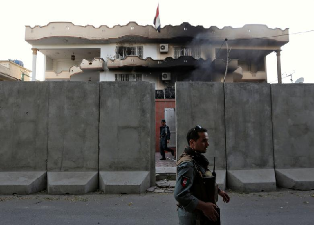 afghan policemen stand guard outside the iraqi embassy after an attack in kabul afghanistan photo reuters