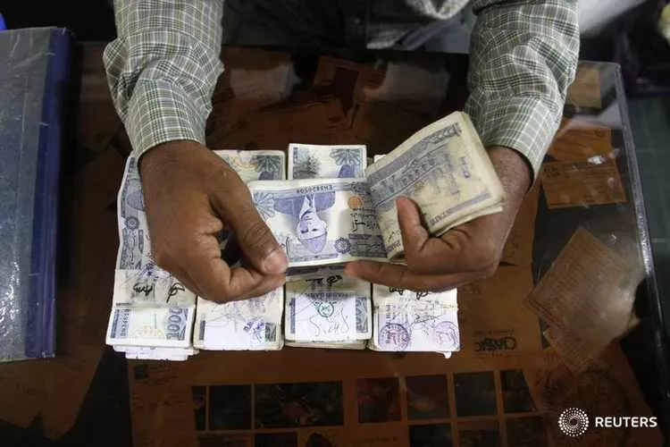 a reuters file photo of a man counting pakistani rupee a reuters file photo of a man counting pakistani rupee