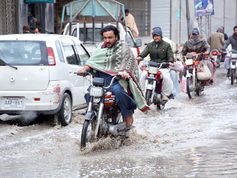 traffic passes through a flooded road photo inp