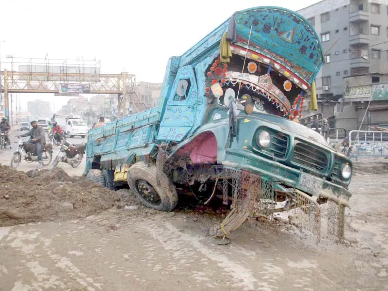 deceived by the sand covering the sinkhole heavy traffic moved towards the road leading to several vehicles getting stuck in the sinkhole on main liaquatabad road which caved in due to a burst water supply line photo online deceived by the sand covering the sinkhole heavy traffic moved towards the road leading to several vehicles getting stuck in the sinkhole on main liaquatabad road which caved in due to a burst water supply line photo online