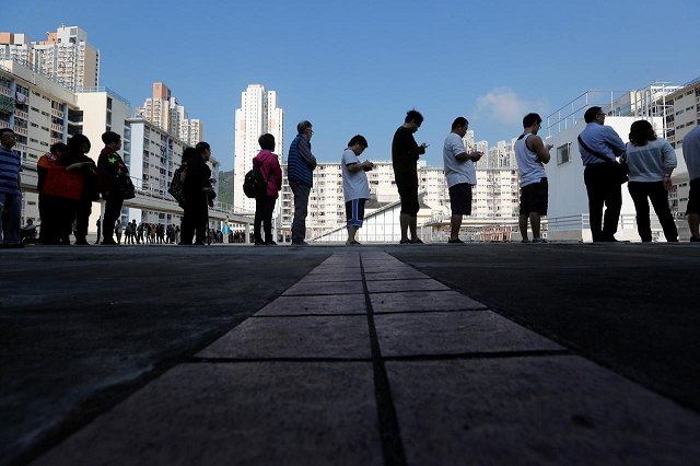 voters queue at a polling station during district council local elections in hong kong china november 24 2019 photo reuters voters queue at a polling station during district council local elections in hong kong china november 24 2019 photo reuters