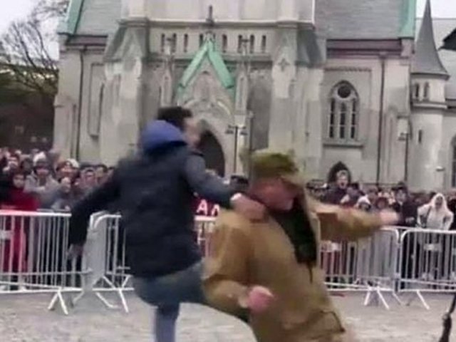 a muslim man could be seen jumping into the barricaded circle to save the holy book from being desecrated screengrab