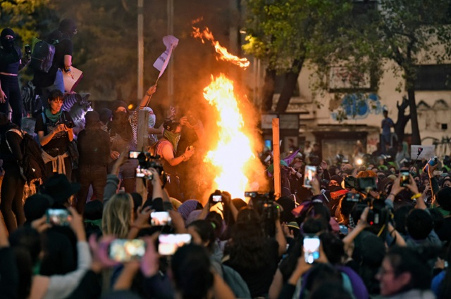 activists protest with fire to mark the international day for the elimination of violence against women photo afp