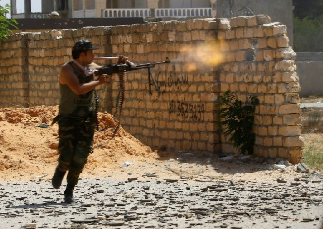 a fighter loyal to libya 039 s internationally recognised government fires during clashes with forces loyal to strongman khalifa haftar in tripoli photo afp