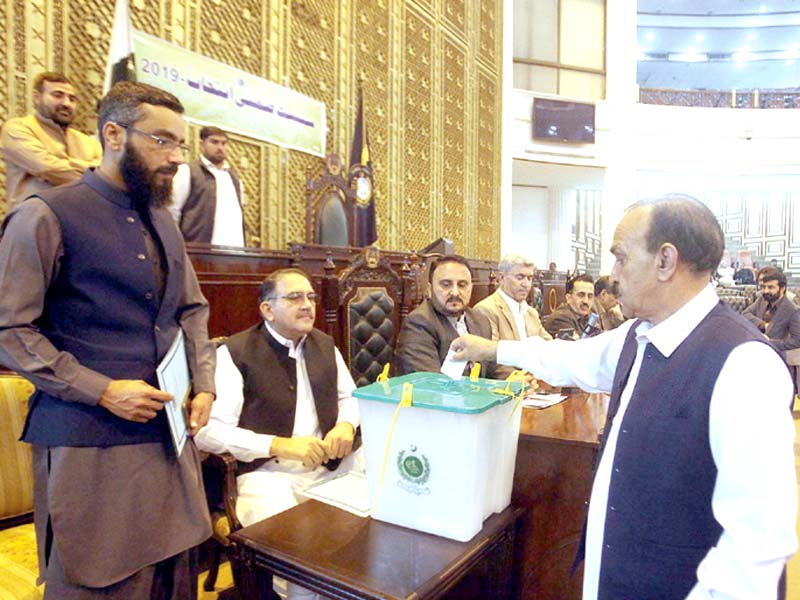 mpas cast their secret ballots during the senate by polls in the k p assembly on tuesday above mpa sobia khan comes out of the designated room after stamping her ballot photos agencies