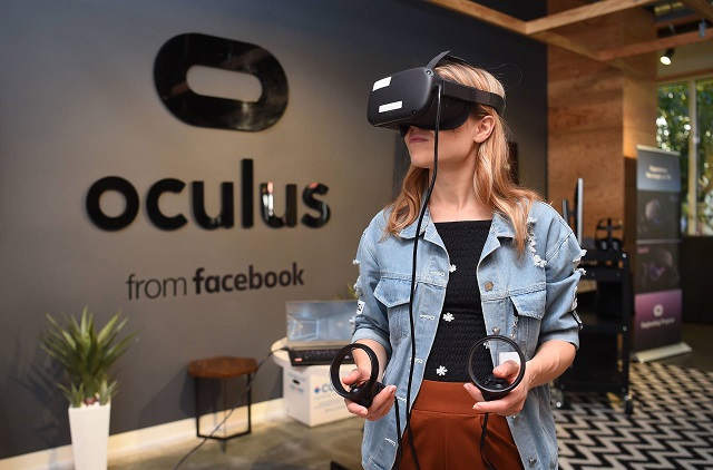 in this file photo taken on october 23 2019 facebook employee elza uzmanoff tries out an oculus device at the company 039 s corporate headquarters campus in menlo park california   facebook owned oculus on november 26 2019 said it is buying the studio behind hit virtual reality game quot beat saber quot as it looks to expand vr technology to wider audiences photo afp