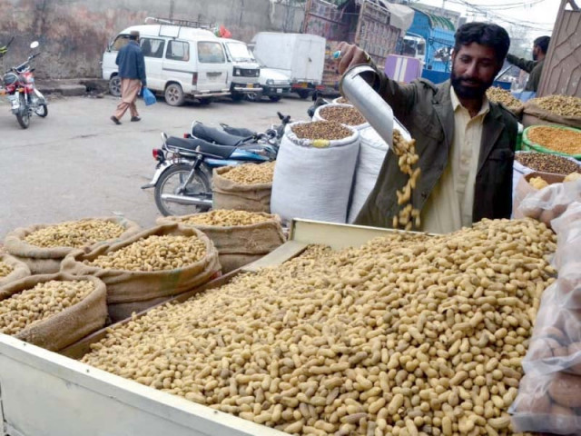 a vendor arranges peanuts on his stall in rawalpindi photo agha mehroz express a vendor arranges peanuts on his stall in rawalpindi photo agha mehroz express