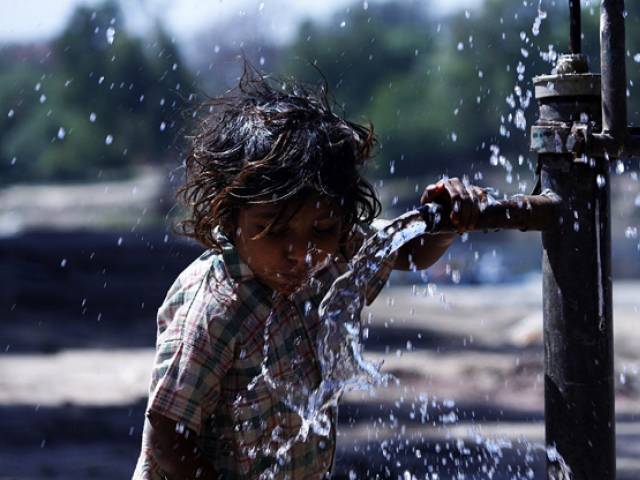 a girl drinking water from a hand pump on the eve of world water day photo online