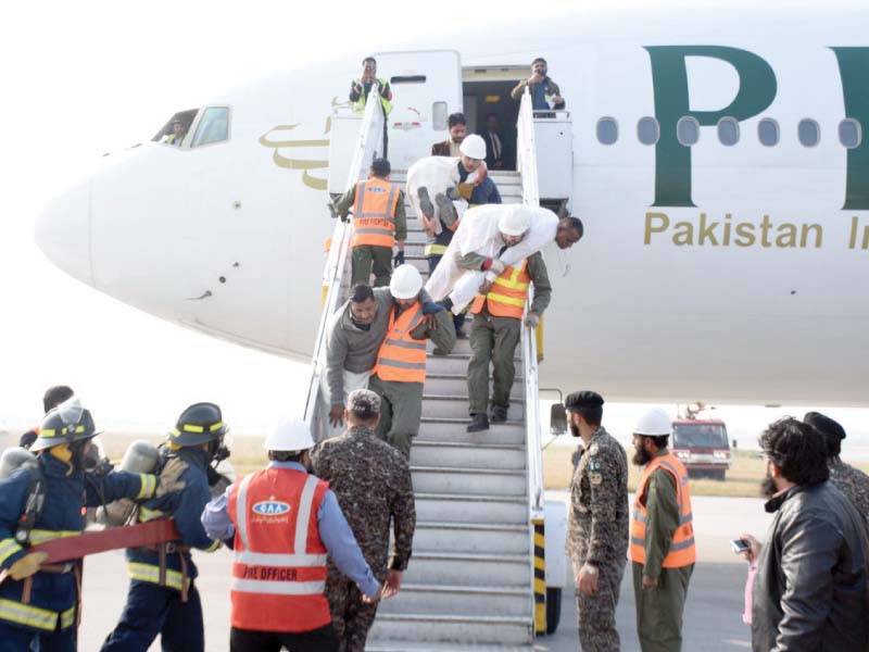 rescuers practice evacuating passengers from a plane during a mock exercise at islamabad international airport photo express