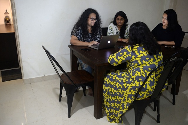 in this photograph taken on october 26 2019 vandita morarka 25 interacts with her colleagues as they sit around rented furniture in mumbai photo afp