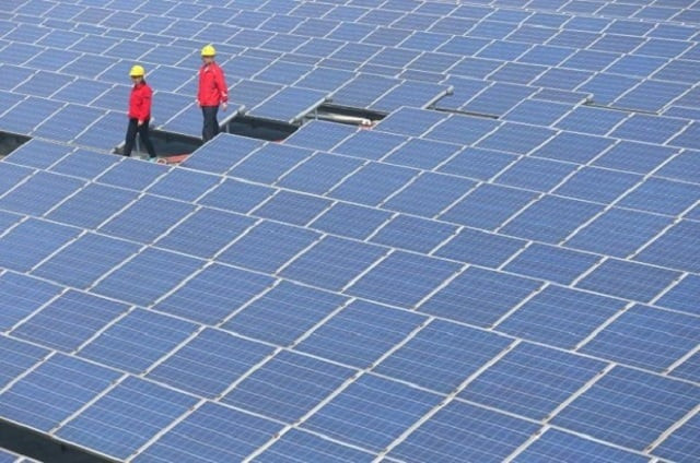 workers walk past solar panels in jimo shandong province china april 21 2016 photo reuters workers walk past solar panels in jimo shandong province china april 21 2016 photo reuters