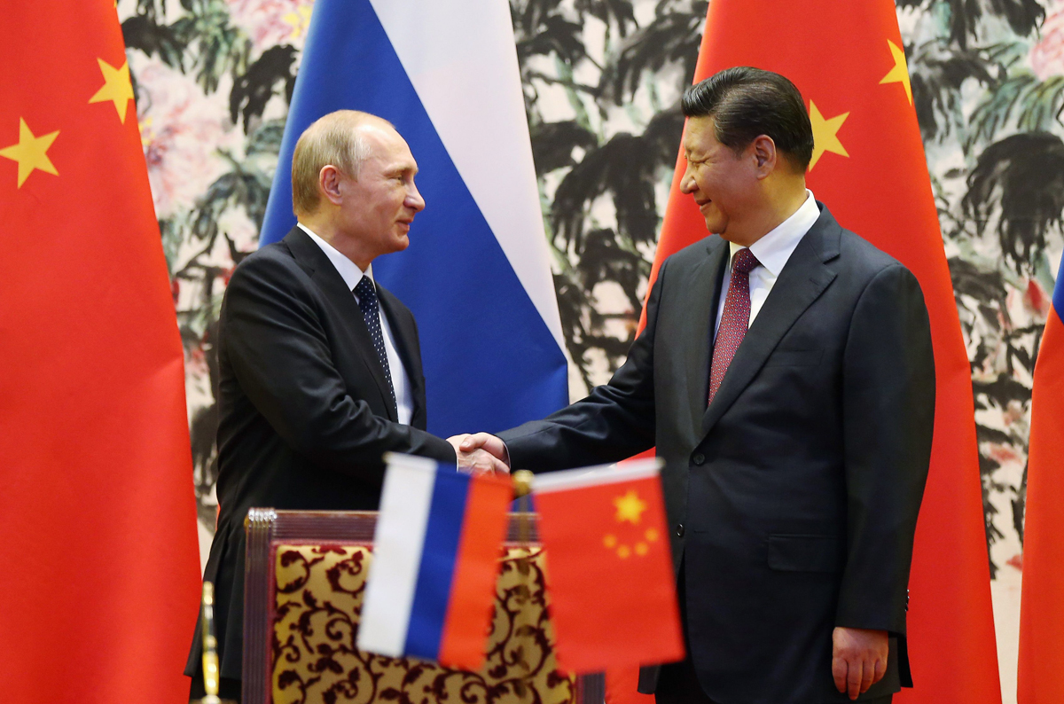 russia 039 s president vladimir putin and his chinese counterpart xi jinping shake hands during a ceremony in beijing in 2014 photo afp file