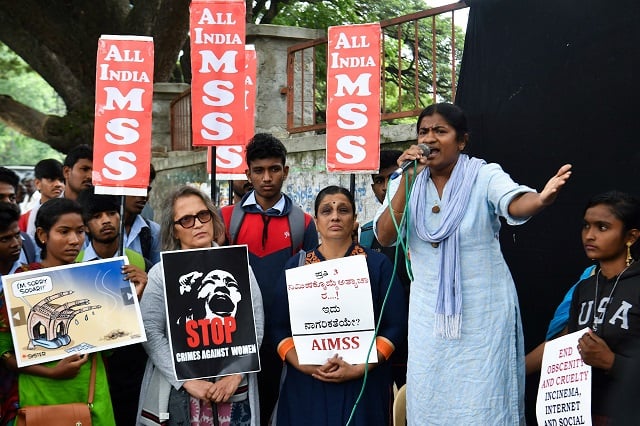 activists and supporters of all india mahila samskrutika sanghatane aimss display placards to protest against the alleged rape and murder of a 27 year old veterinary doctor in hyderabad during a demonstration in bangalore on december 2 2019 photo afp