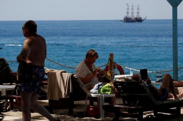 tourists enjoy a sunny day in fethiye turkey photo reuters tourists enjoy a sunny day in fethiye turkey photo reuters