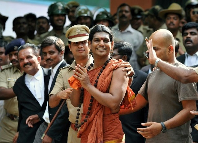 police escort controversial hindu godman swami nityananda centre in 2012 after he appeared at a bail hearing in ramanagar district some 50 kilometres from bangalore india photo afp