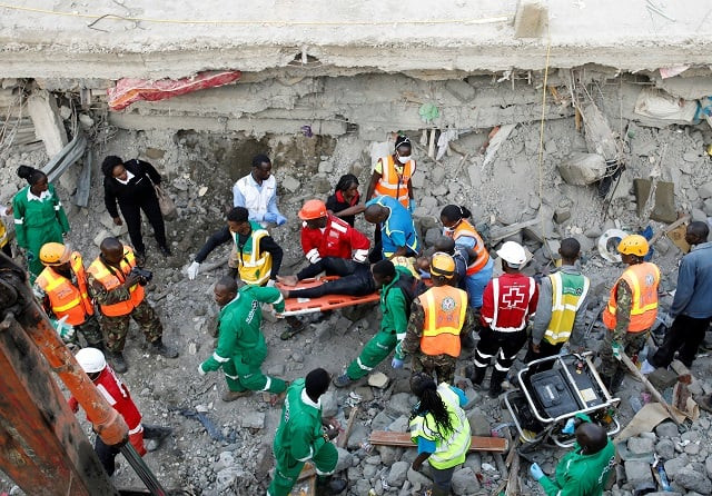 crowds of people watch as rescue teams search the scene where a building collapsed in nairobi kenya photo reuters crowds of people watch as rescue teams search the scene where a building collapsed in nairobi kenya photo reuters