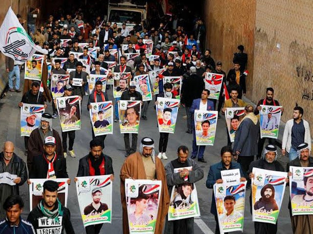 iraqi demonstrators from nassiriya city hold the pictures of people who were killed during ongoing anti government protests in baghdad iraq december 6 2019 photo reuters