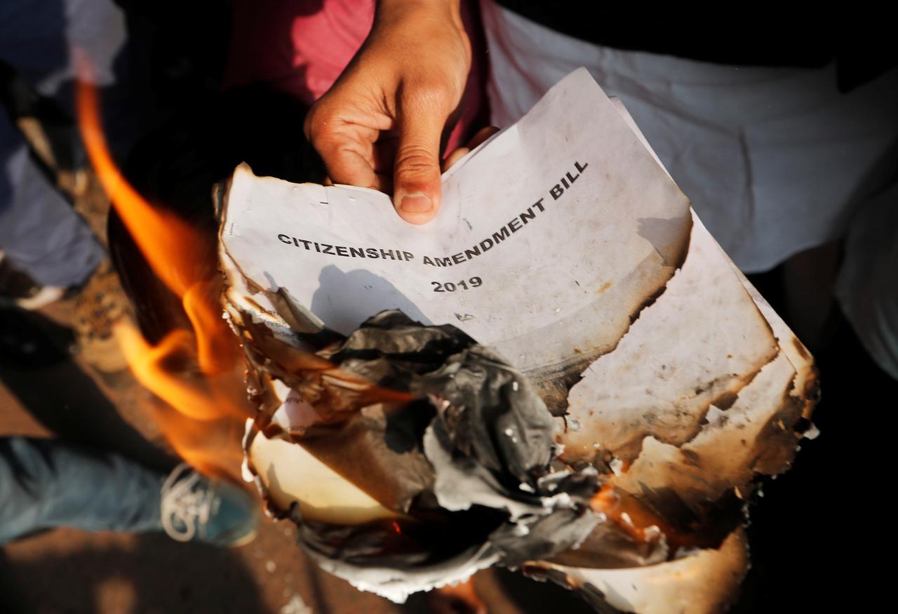 demonstrators burn copies of citizenship amendment bill a bill that seeks to give citizenship to religious minorities persecuted in neighbouring muslim countries during a protest in new delhi india december 11 2019 photo reuters