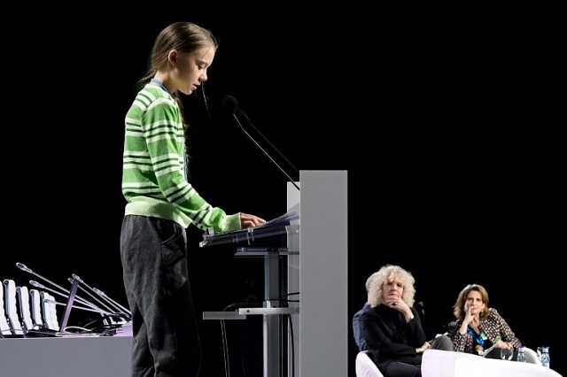 swedish climate activist greta thunberg gives a speech during the cop25 un climate change conference in madrid with greenpeace international executive director jennifer morgan and spanish environment minister teresa ribera in the background photo afp