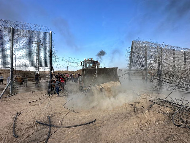 Palestinians break into the Israeli side of Israel-Gaza border fence after gunmen infiltrated areas of southern Israel, October 7: REUTERS