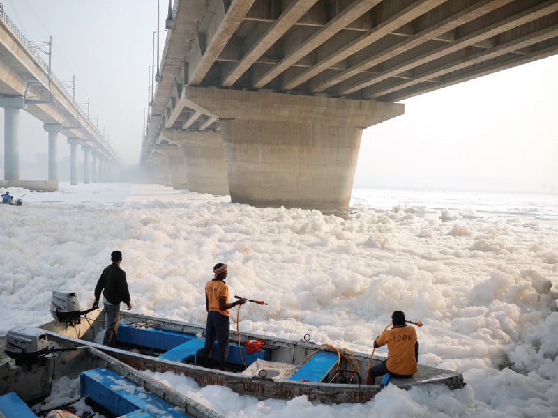 workers with the delhi government spray chemicals to clean the toxic foam in the polluted yamuna river in new delhi photo reuters