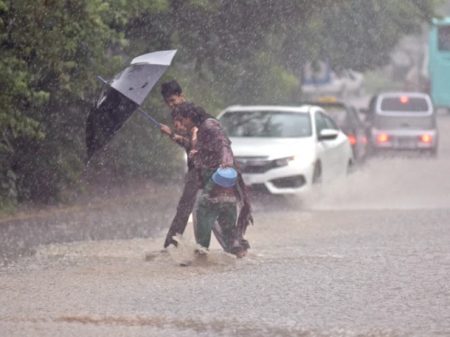 citizens enjoy splashing across a water logged road amid the heavy monsoon downpour in the federal capital photo online citizens enjoy splashing across a water logged road amid the heavy monsoon downpour in the federal capital photo online