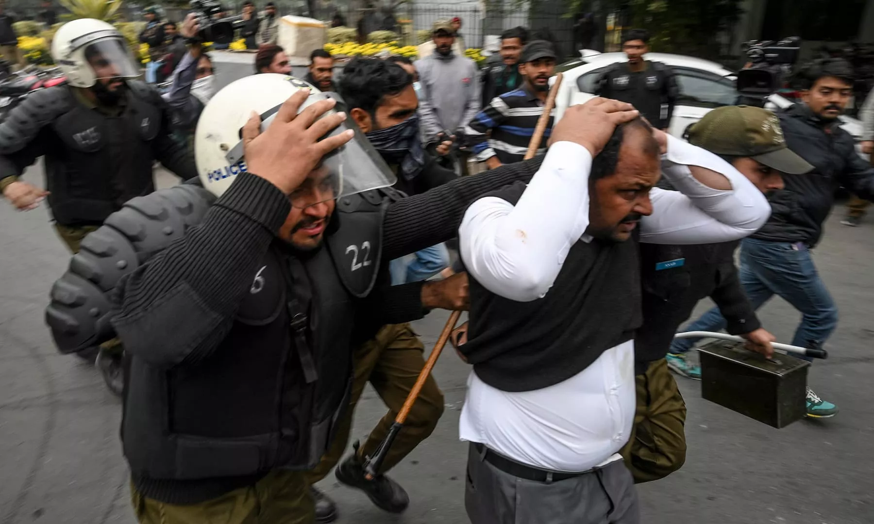 policemen detain a lawyer r following a clash between lawyers and doctors in lahore afp file policemen detain a lawyer r following a clash between lawyers and doctors in lahore afp file