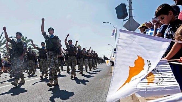 people in nicosia wave flags during a military parade marking the 59th anniversary of cyprus 039 independence from british colonial rule in october 2019 photo afp