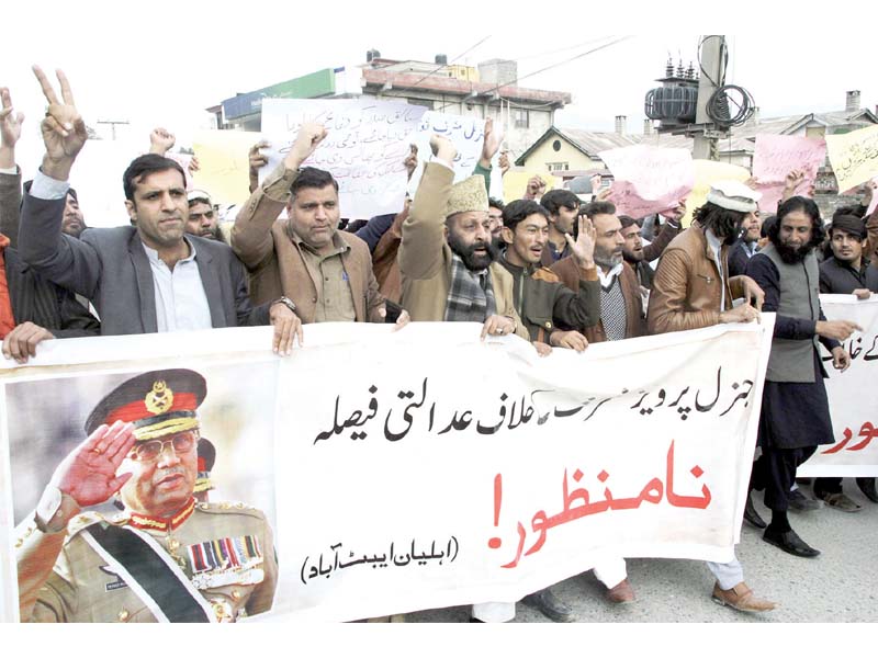 men march on the karakoram highway in abbottabad on wednesday to protest against the special court s verdict against former dictator general pervez musharraf photo online