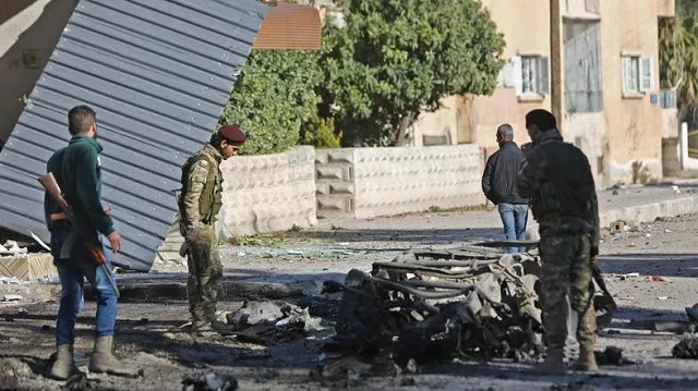 turkish backed syrian fighters stand at the scene of a car bomb explosion in ras al ain on december 4 2019 photo afp turkish backed syrian fighters stand at the scene of a car bomb explosion in ras al ain on december 4 2019 photo afp