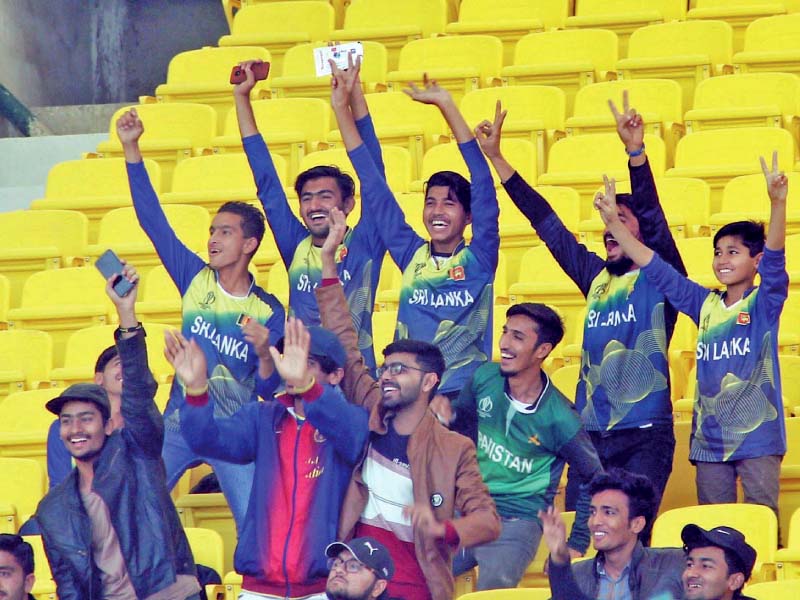 a handful of fans celebrate at the test match that was held at the national stadium in karachi the number of spectators remained low despite the long wait fans have endured for international test cricket photo online