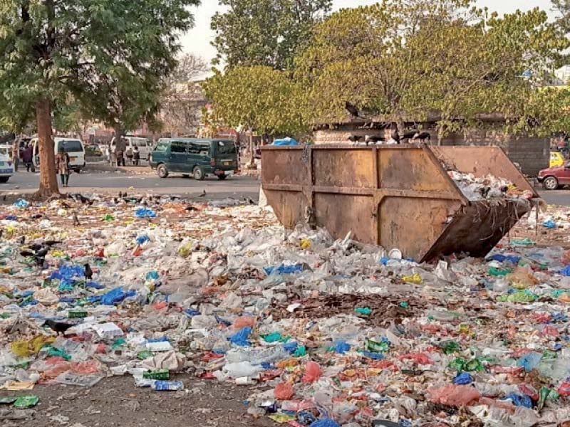 a roadside is littered as sanitary workers observe strike in islamabad photo express