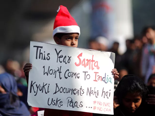 a girl wearing a santa claus hat holds a placard as she attends a protest against a new citizenship law outside the jamia millia islamia university in new delhi india december 25 2019 photo reuters a girl wearing a santa claus hat holds a placard as she attends a protest against a new citizenship law outside the jamia millia islamia university in new delhi india december 25 2019 photo reuters