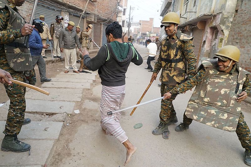 in this picture taken on december 20 2019 police personnel baton charge a protester during a demonstration against the controversial citizenship law in varanasi photo afp
