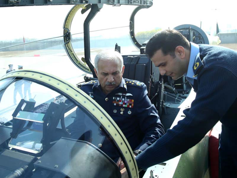air chief marshal mujahid anwar khan sitting in the cockpit of dual seat jf 17 thunder aircraft during the roll out ceremony photo pn