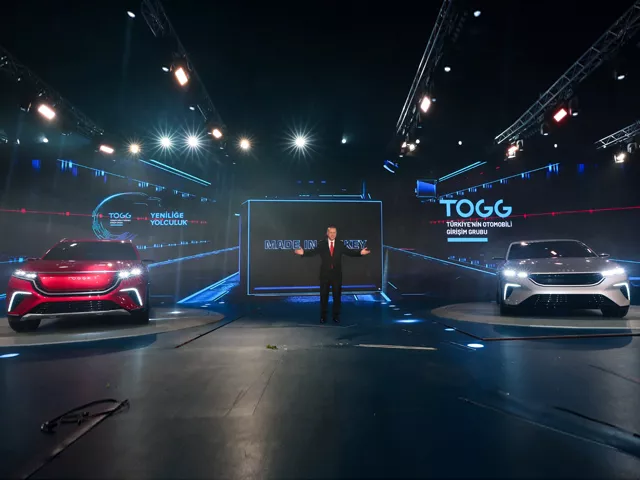 a handout photograph taken and released by the turkish president press service on december 27 2019 shows turkish president recep tayyip erdogan delivering a speech next to the firsts turkish made electric cars by the togg company during the launching ceremony in the gebze district of kocaeli photo afp a handout photograph taken and released by the turkish president press service on december 27 2019 shows turkish president recep tayyip erdogan delivering a speech next to the firsts turkish made electric cars by the togg company during the launching ceremony in the gebze district of kocaeli photo afp