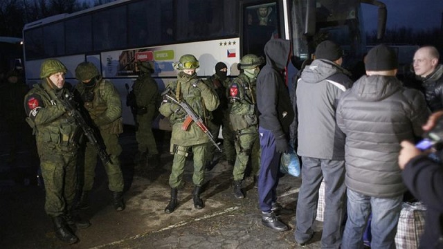 ukrainian servicemen who were made prisoners wait during a prisoner exchange between ukraine and pro russia rebels on the check point near the city of gorlivka photo afp