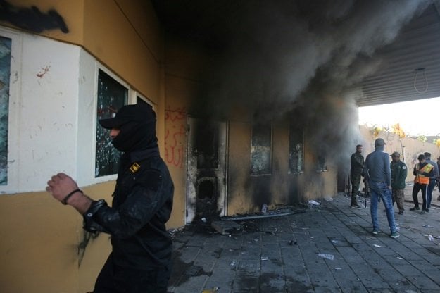 smoke billows from the entrance of the us embassy in the iraqi capital baghdad after supporters and members of the hashed al shaabi military network tried to break into the building during a rally to vent anger over deadly us air strikes photo afp