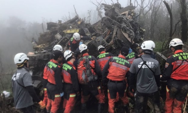 rescuers search for missing military officers after a black hawk helicopter made a forced landing at a mountainous area near taipei photograph photo reuters