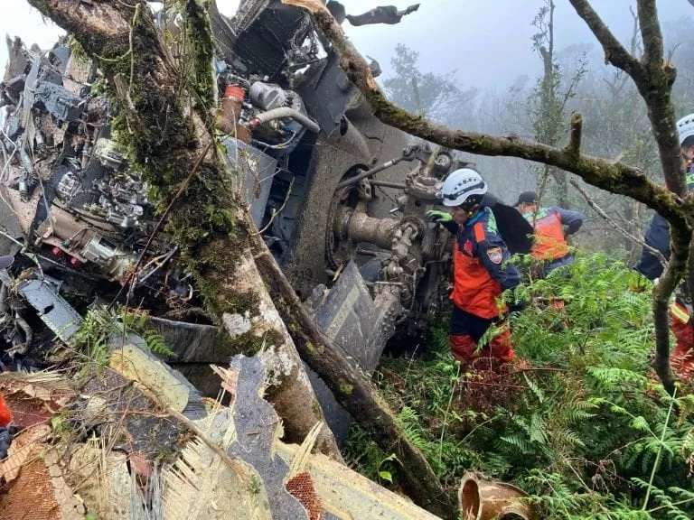 rescuers searching for survivors after a military black hawk helicopter smashed into mountains in yilan county near taipei photo afp rescuers searching for survivors after a military black hawk helicopter smashed into mountains in yilan county near taipei photo afp