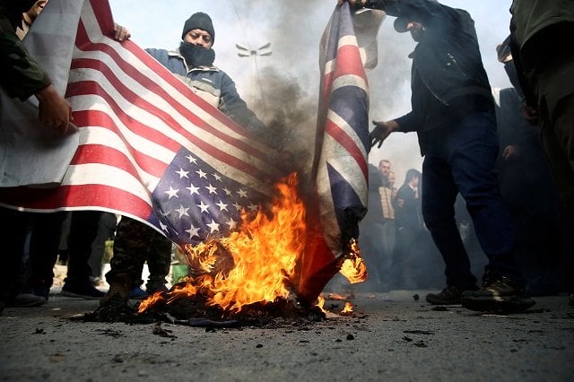 demonstrators burn the us and british flags during a protest against the assassination of the iranian major general qassem soleimani head of the elite quds force and iraqi militia commander abu mahdi al muhandis who were killed in an air strike in baghdad airport in tehran photo reuters