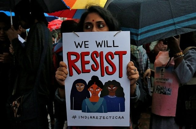 a demonstrator displays a placard as she attends a protest rally against a new citizenship law in kolkata india january 3 2020 photo reuters a demonstrator displays a placard as she attends a protest rally against a new citizenship law in kolkata india january 3 2020 photo reuters