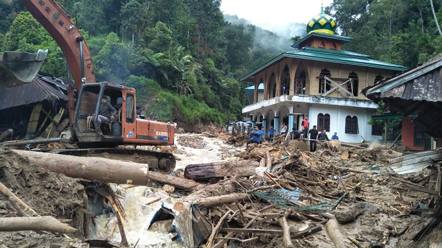 people use a heavy equipment to remove debris after flash floods hit the saladi village in mandailing natal north sumatra photo afp