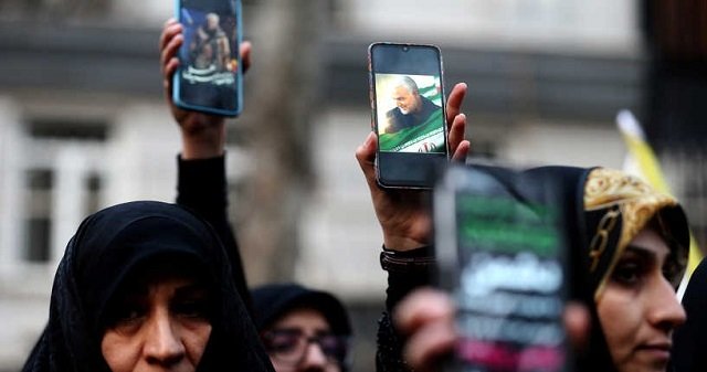 iranian demonstrators hold up mobile phones showing the picture of the late iranian major general qassem soleimani during a protest against the killing of soleimani head of the elite quds force and iraqi militia commander abu mahdi al muhandis who were killed in an air strike at baghdad airport in front of united nations office in tehran iran january 3 2020 photo reuters file