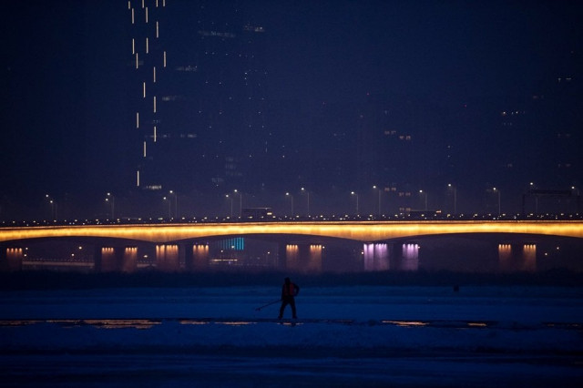 this photo taken on december 10 2019 shows a worker on the frozen songhua river in harbin in china 039 s northeastern heilongjiang province ahead of the harbin international ice and snow festival photo afp this photo taken on december 10 2019 shows a worker on the frozen songhua river in harbin in china 039 s northeastern heilongjiang province ahead of the harbin international ice and snow festival photo afp