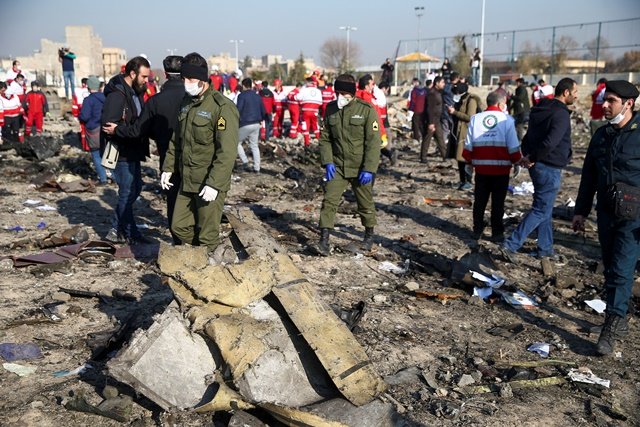 security officers and red crescent workers are seen at the site where the ukraine international airlines plane crashed after take off from iran 039 s imam khomeini airport on the outskirts of tehran iran january 8 2020 nazanin tabatabaee wana west asia news agency via reuters