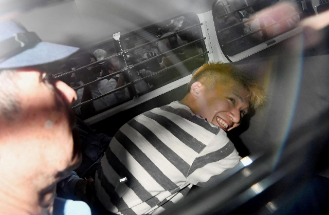 satoshi uematsu suspected of a deadly attack at a facility for the disabled is seen inside a police car as he is taken to prosecutors at tsukui police station in sagamihara kanagawa prefecture japan photo reuters