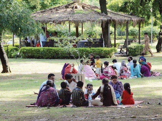 families at a picnic in a park photo file